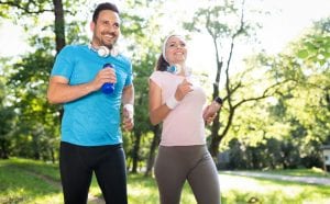 Happy couple running and exercising together outdoor