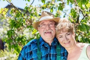 Mature couple embracing time together in the garden.