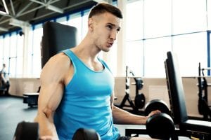 Strong Man Working Out in Gym